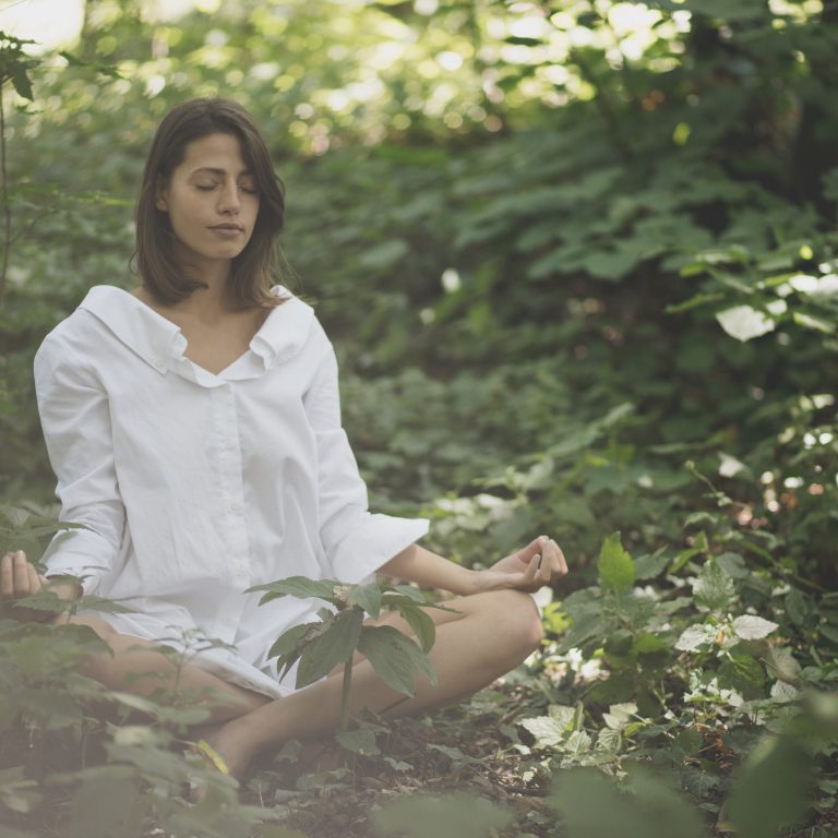 Beauty woman in nature Yoga position.  Spring season.